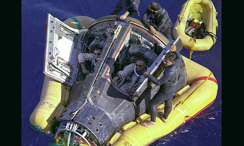 Recovery of Gemini 8 from the western Pacific Ocean; Armstrong sitting to the right.