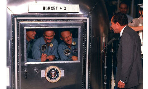 The Apollo 11 crew and President Richard Nixon during the post-mission quarantine period.
